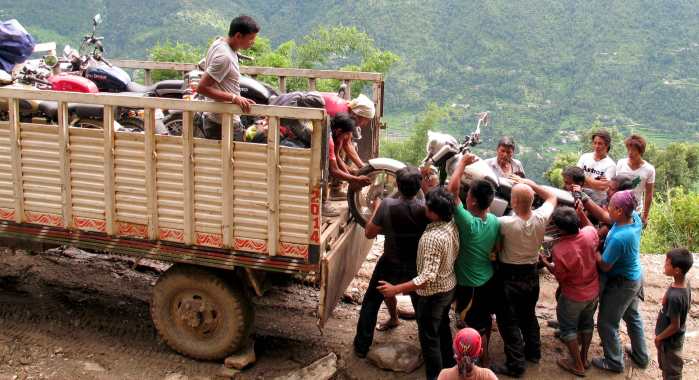 Motorcycles get loaded on the 4x4 truck near Sindhupalchowk, Nepal
